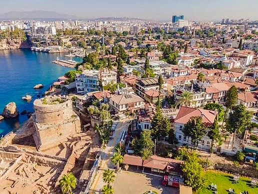 Antalya'nın tarihi ve modern yapılarıyla dolu sahil manzarası, yaz sezonu iş fırsatlarını simgeliyor.